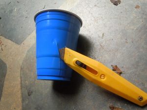 make a couple of vertical cuts in the sides of four plastic cups